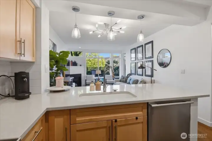 The quartz counters and tile surround are perfect with the warm wood cabinetry.