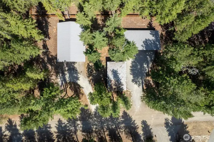 Aerial view of the property and buildings with Littel RD in the foreground, double lot in Lost River Airport development.