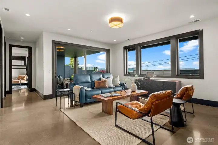 Warm and inviting living area with large windows and abundance of natural light.