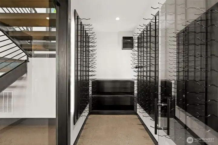 Custom wine room with glass enclosures, ideal for showcasing and storing your collection.