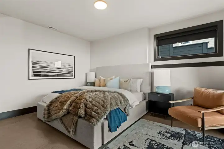 Lower level bedroom with 3/4 bathroom, offering a comfortable and private space for guests or flexible living.