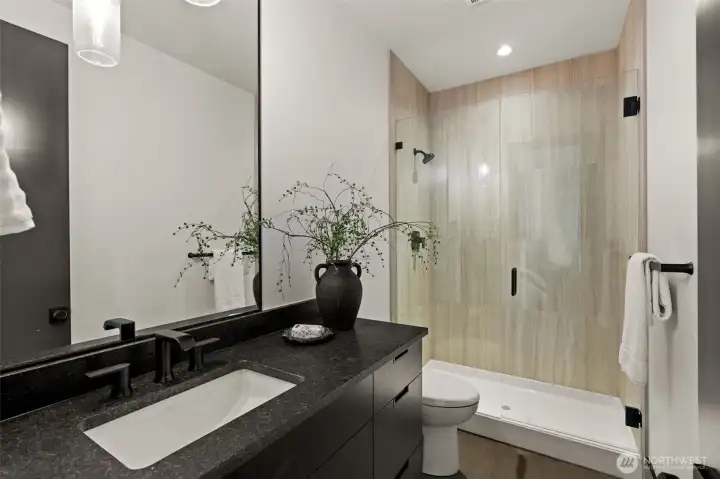 Connected 3/4 en suite bathroom with sleek finishes, glass shower, and stylish vanity for added comfort and convenience.