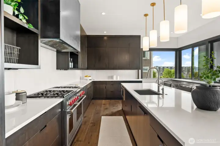Thoughtfully designed kitchen with gas range, and abundant cabinetry, complemented by natural light and pleasant outlooks.