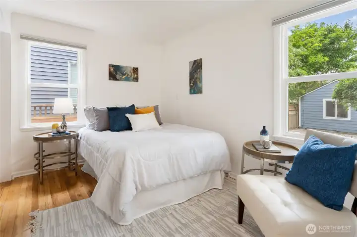 One of two bright and airy bedrooms on the main level - this one includes custom Elfa organizers for all your favorite fashions.
