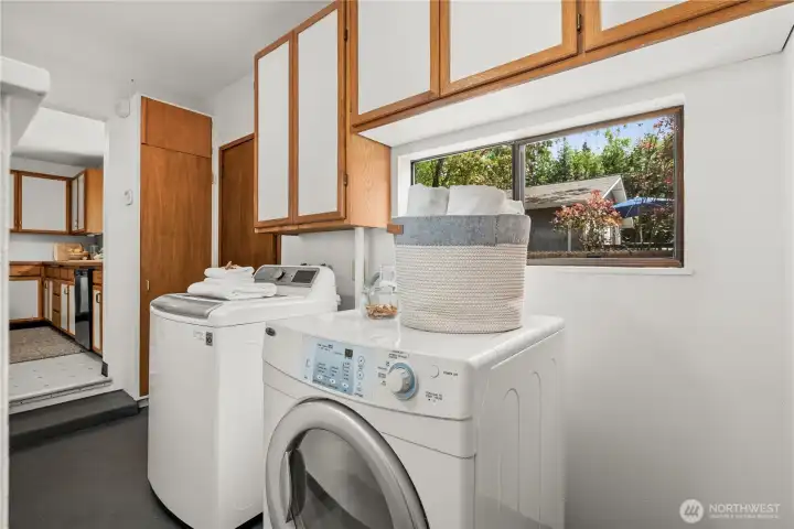 Functional laundry room with convenient extra storage.