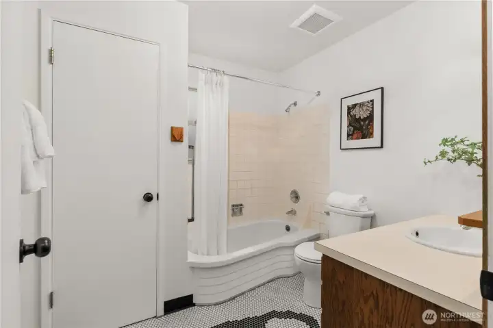 Spacious full bathroom complete with a bathtub and great storage.