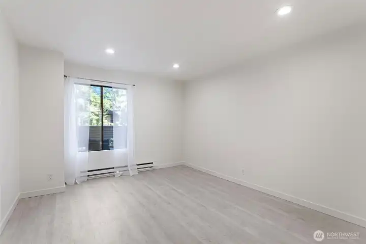 The primary bedroom overlooks the private deck, offering abundant natural light throughout the space.