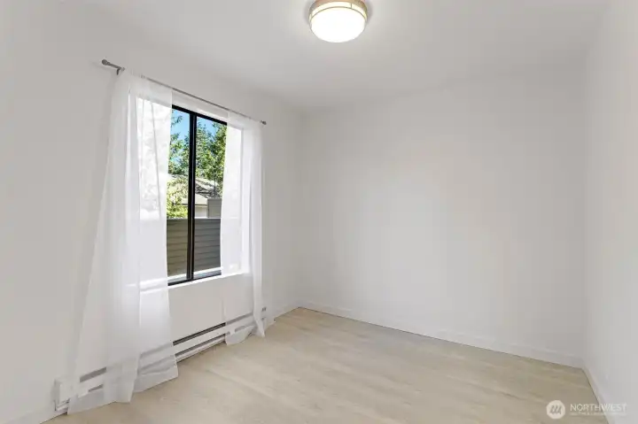 The dining room features views of the deck and flows effortlessly into the kitchen and living room, creating a bright, open space ideal for both daily living and entertaining.
