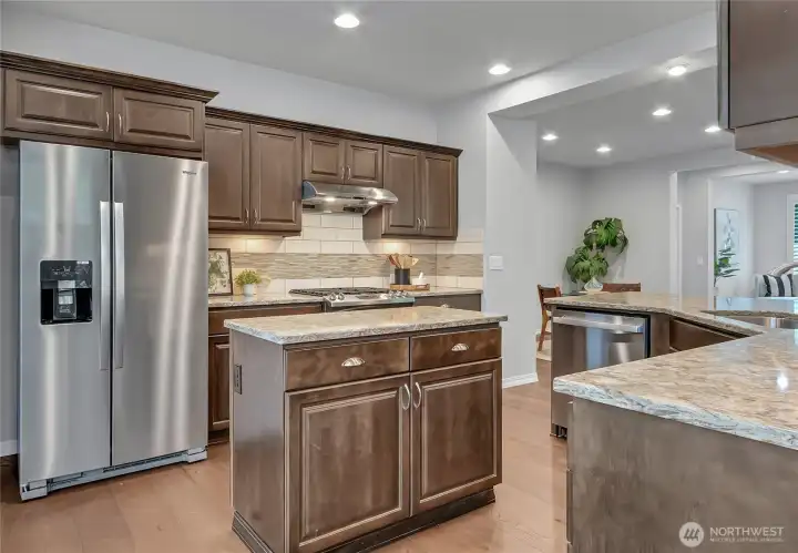 BOTH an island and peninsula with electrical outlets for your appliance convenience. (You can NOT get that in new construction!!!). Brand new refrigerator - too COOL!