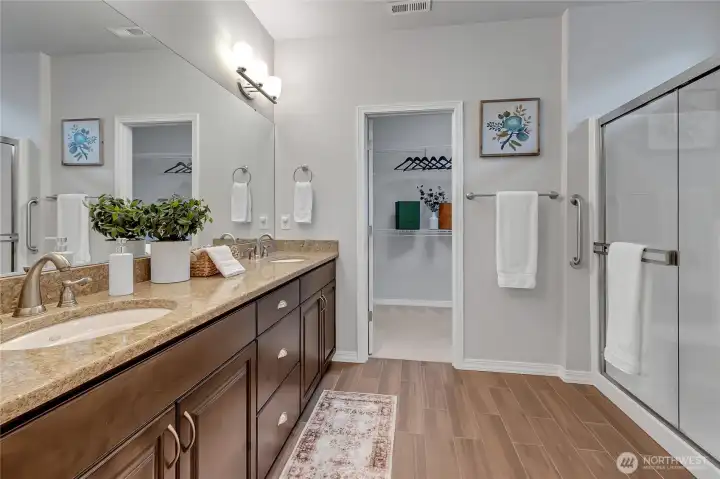 Safe step-in shower in the primary bathroom plus huge vanity and double undermount sink, of course. Transom window above the shower brightens the room naturally (not in view in this photo). Huge walk-in closet too!