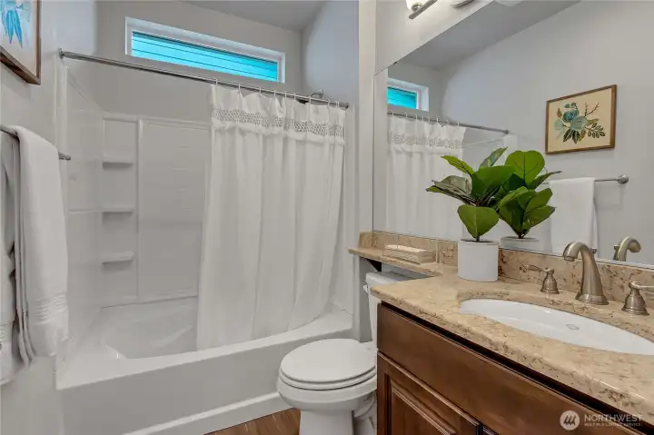 Full bath with transom window for natural light and here's a secret (materials used in this home are virtually exactly like those of some new construction in the area). But, these homes are finished with landscaping and other updates. Compare for yourself and you'll be sure to LOVE Trilogy - especially this home!...