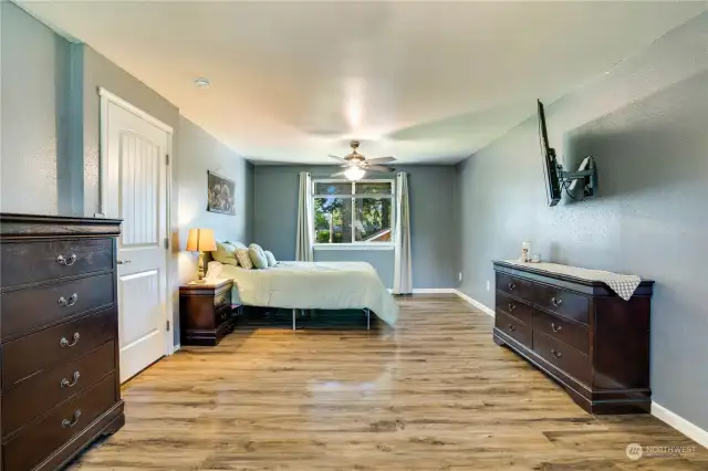 Generous primary bedroom with ample space for furniture and closet space.