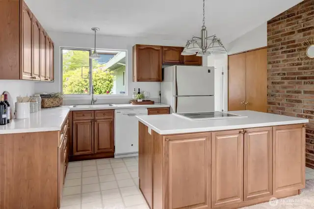 Open kitchen with quartz counters and large center island