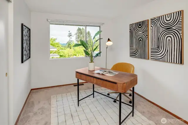 Three upper level bedrooms (including Primary). This bedroom staged as an office. Windows take in the views to the east