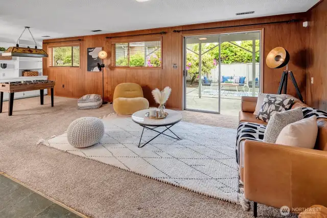 Lower level Rec Room with beautiful wood paneling and walk-out slider to patio and mature gardens