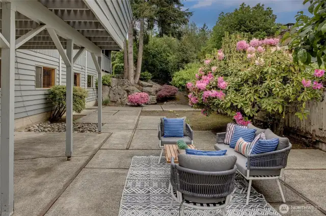 Lower level patio with fenced yard and mature landscaping