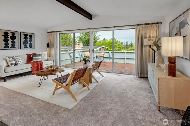 Living room opens to a large wrap-around deck, taking in lots of light and views to the Southeast