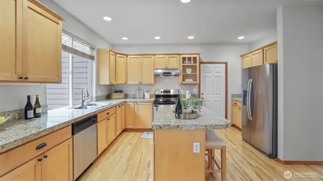 Gourmet kitchen features granite countertops and stainless steel appliances.