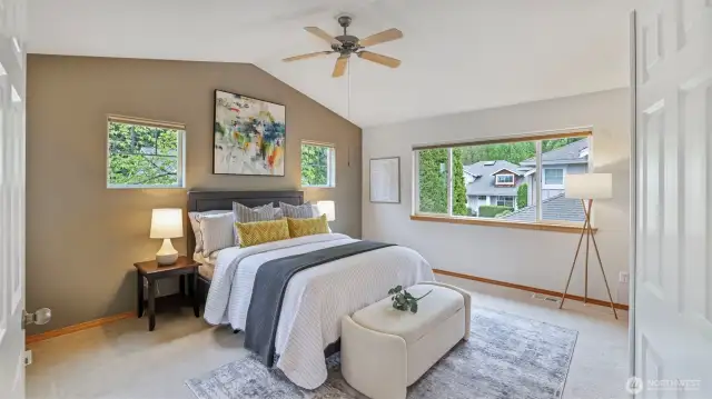 Upstairs, vaulted primary suite offers a tranquil escape.