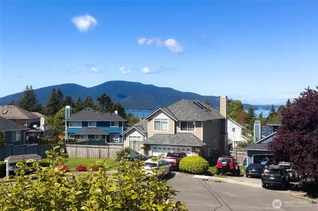 view from the front of the house, of the quiet neighborhood and cul-de-sac.  plus filtered view of the sound.
