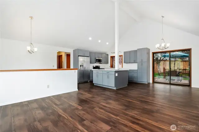 Open living & brand new kitchen with vaulted ceilings, dining area leads to large deck & fence backyard with all new floors.