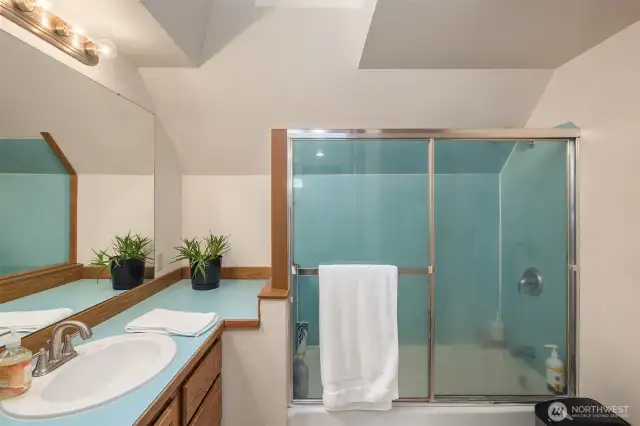 Nice bath has a large vanity with ample storage below.