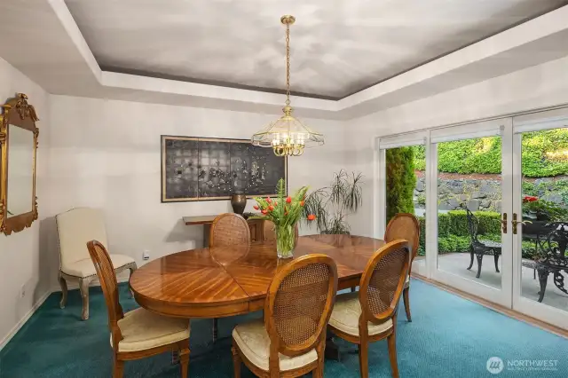 Large formal dining room has French doors that open to a gorgeous patio extending your entertainment space to dine outdoors.