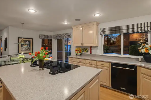 The large center island holds cook station and meal prep area plus more storage cabinets.
