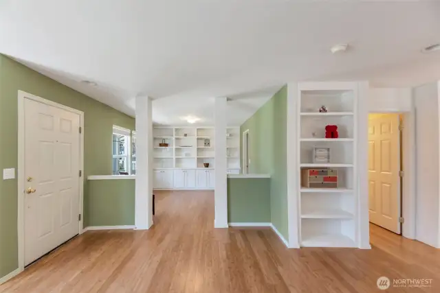 Main floor entry with built in shelving, rich hardwood flooring