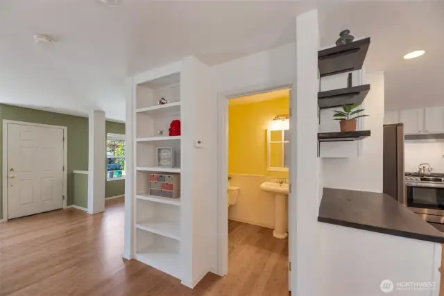 Built in shelving on main floor between living, dining, and kitchen