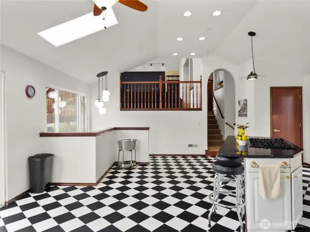 Open kitchen with stairs to lower level.