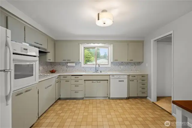 Updated kitchen backsplash with freshly painted cabinets.