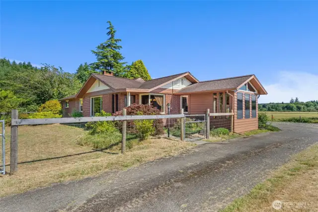 Main home with fenced front yard.