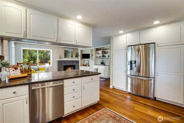 This kitchen includes a lot of cabinetry for easy storage. Notice the tall pantry cupboards beside the fridge and the dishwasher-new in 2024.