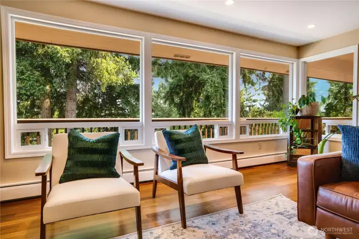 Picture windows extend along the wall and even turn the corner, allowing for the most natural light and calming views. Notice the smaller windows below that slide open for airflow.