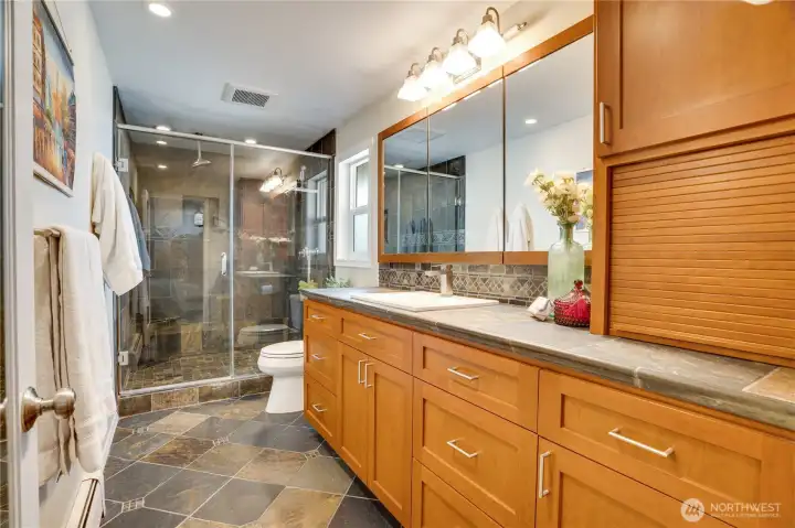 The private, tiled bathroom offers generous storage space in the vanity.