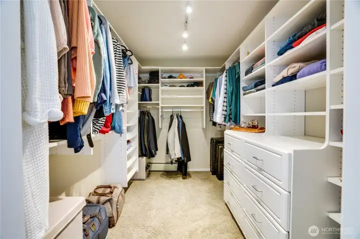 The walk-in closet is all set with a complete closet organizer and a built-in dresser to keep clothes, shoes, and accessories organized.