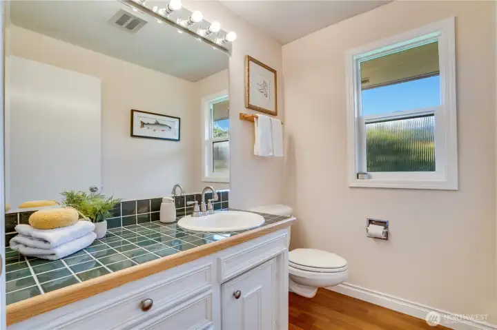 A half bath is conveniently placed next to the office and just outside the kitchen area for friends who drop by. This home offers 5 separate bathrooms: 2 on the main floor, 2 on the 2nd floor, and 1 in the daylight basement.