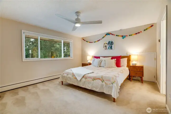 Take the stairs up to the 2nd floor to visit 3 more bedrooms each with a walk-in closet. Along with the primary suite below, this bedroom at the top of the stairs includes a private bathroom.