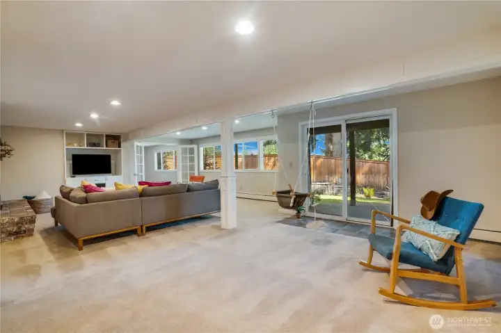 This lower level of the home is excellent for out-of-town guests, or a housemate, and has great potential as a rental space too. French doors open to the playroom just beyond the living room and from there a door leads to a large storage space.