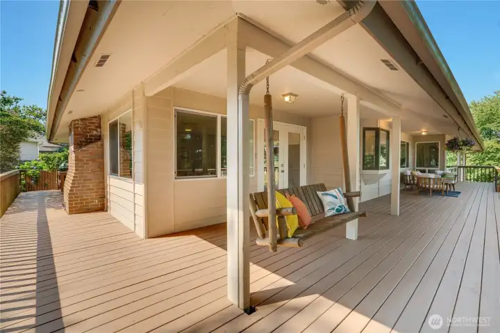 Comfort and space define this home with its hardwood floor, multiple fireplaces, wraparound deck, and room for everyone to gather together.