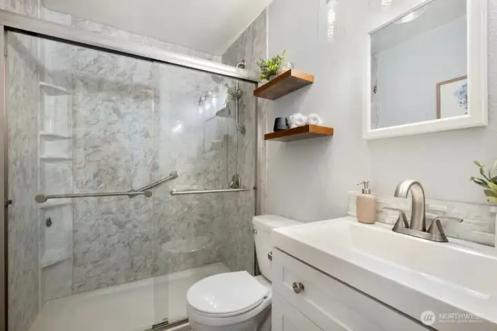 Fully refurbished bathroom includes a walk-in shower that can easily convert back to a tub