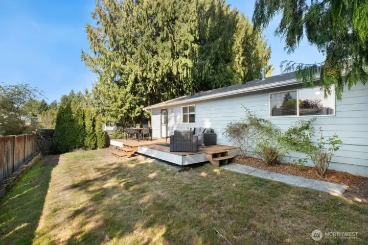 Fully fenced backyard with garden space perfect for entertaining, pets, and playtime!