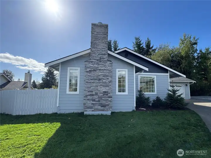 Updated Rambler, fresh exterior paint and a spacious front yard, partially fenced.
