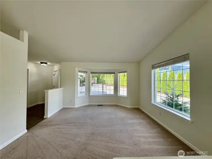 Cozy living room with great windows and plush carpet.