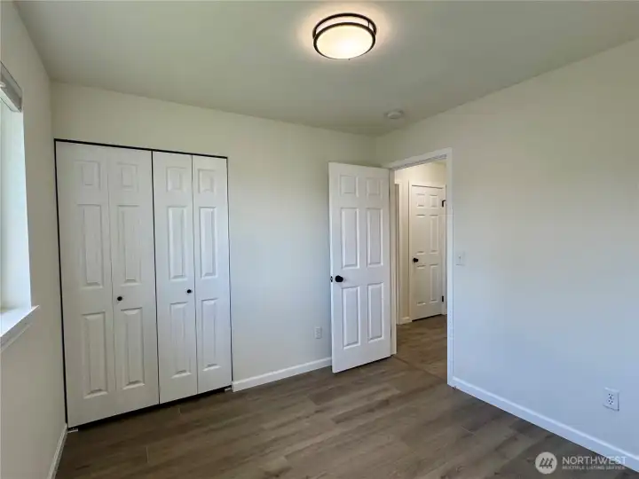 Second bedroom with vinyl plank flooring.