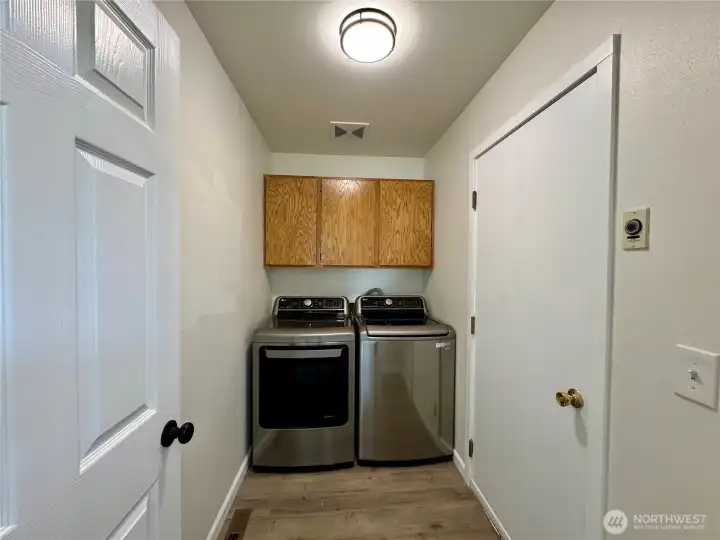 Separate utility room with storage cabinets.