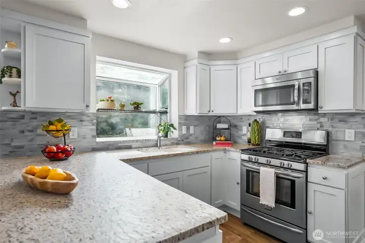 Slab granite countertops and stainless steel appliances