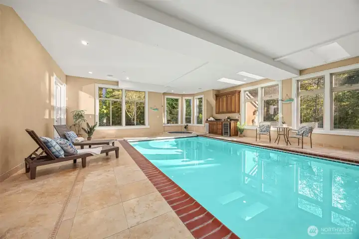 Indoor pool with shower, half bath and pool bar