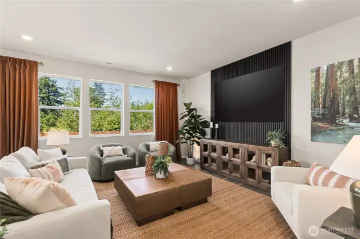 Open great room with large windows for natural light. Actual home is under construction and finishes, materials, and colors will vary. See site agent for details.